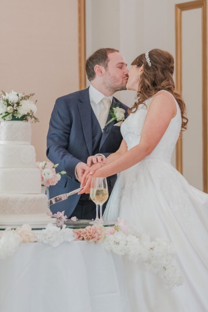 127 groom kisses bride cake cutting ceremony kimpton fitzroy london hotel oxford wedding photographer