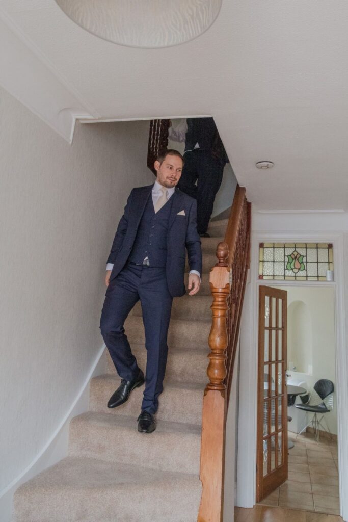 14 groom bestman descend stairs london oxford wedding photographer
