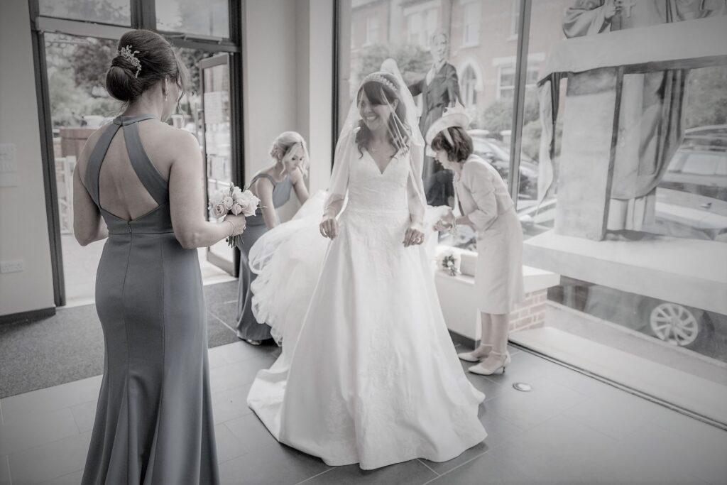 30 bridesmaids adjust brides gown st peter in chains church north london oxfordshire wedding photographers