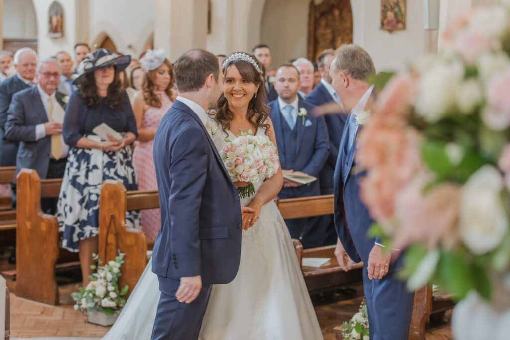 36 smiling bride meets groom st peter in chains church alter north london oxfordshire wedding photographers