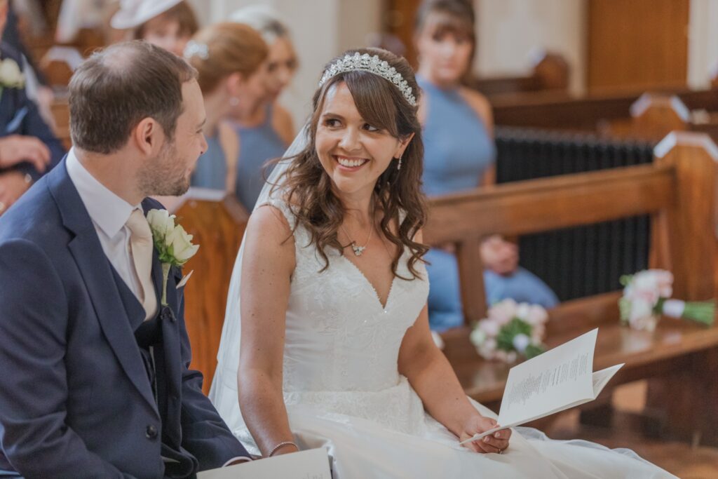 52 bride groom exchange smiles st peter in chains ceremony north london oxfordshire wedding photographer