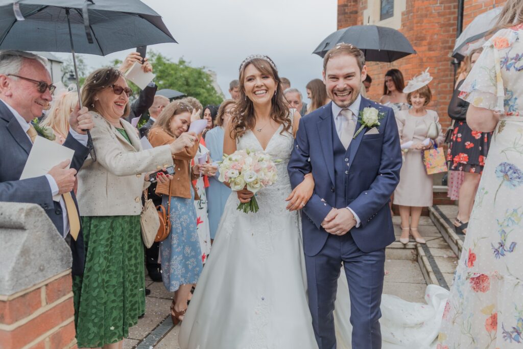 63 bride groom enjoy confetti parade st peter in chains church north london oxfordshire wedding photographer