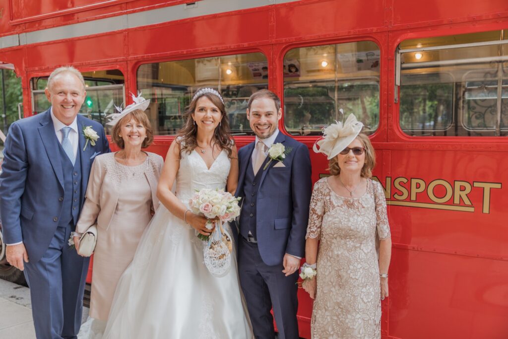 78 bridal party beside red double decker bus russell square london oxford wedding photographer