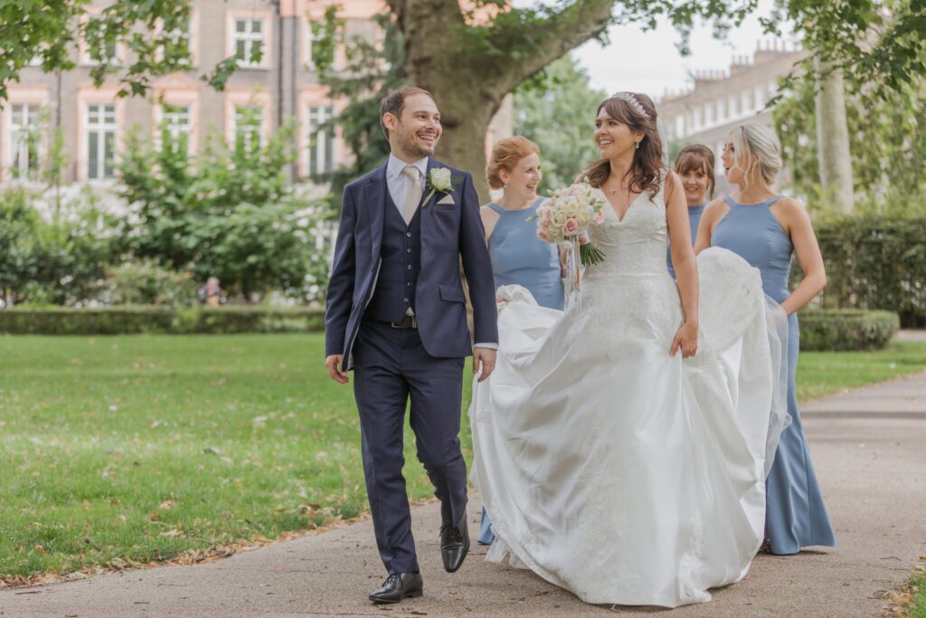 81 bridesmaids carry brides gown train russell square gardens london oxfordshire wedding photographer