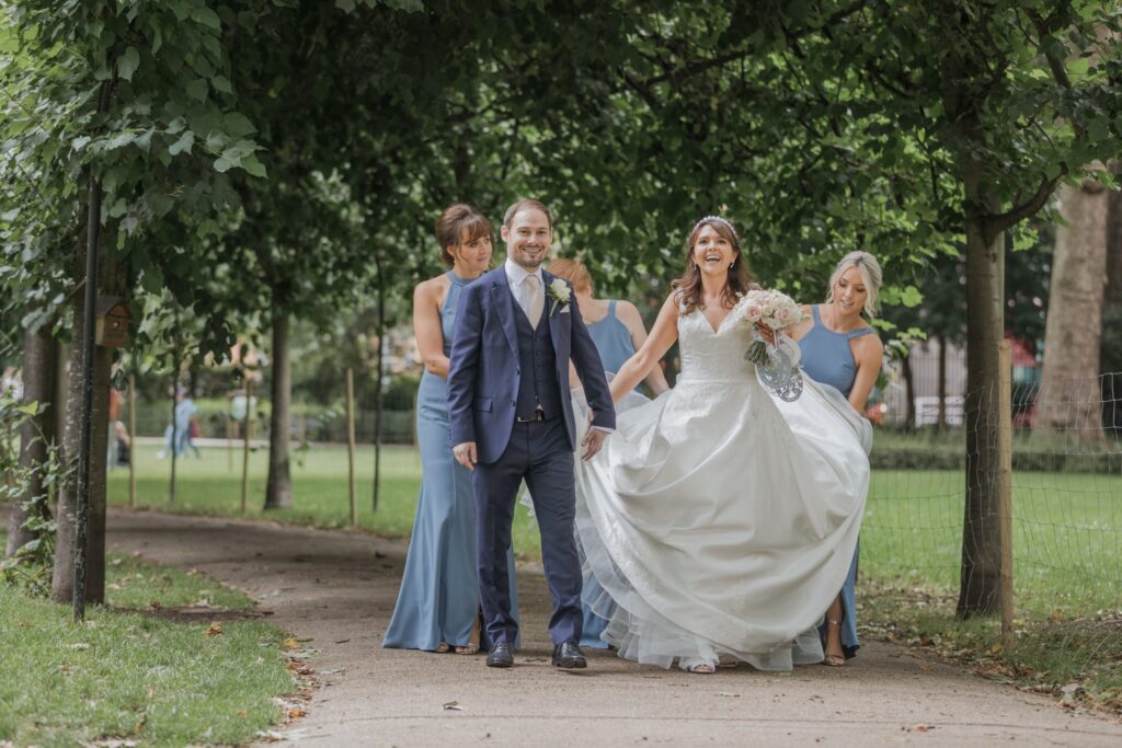 82 laughing bride groom bridesmaids stroll russell square park central london oxfordshire wedding photographers