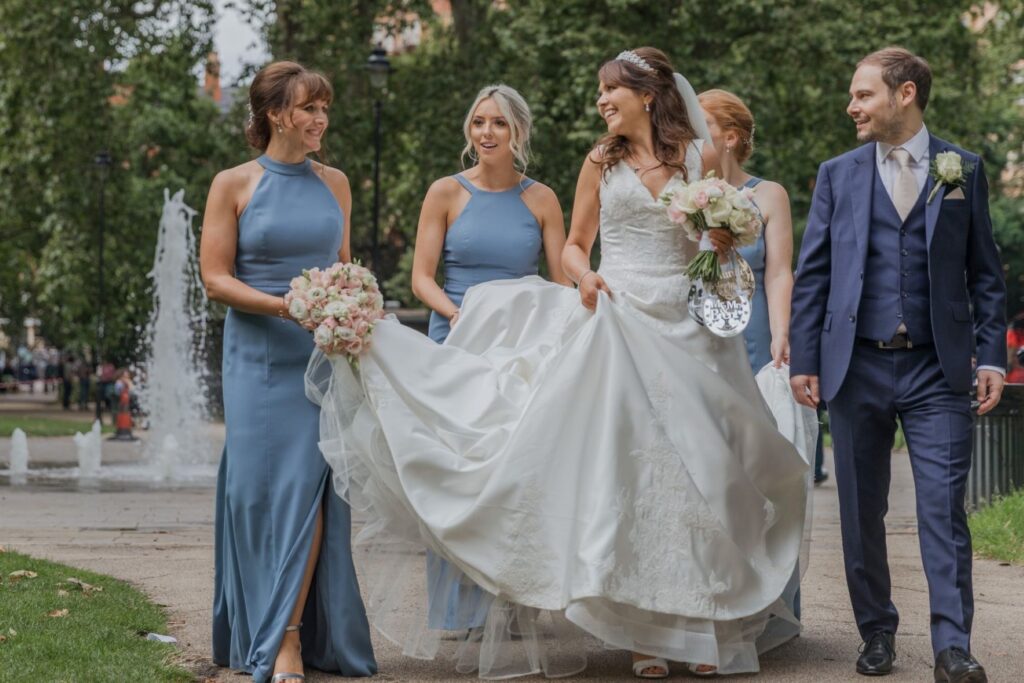 85 bridal party stroll past water fountain russell square gardens central london oxford wedding photographers