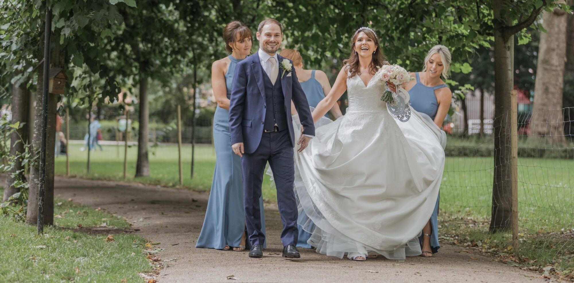 laughing bride groom bridesmaids stroll russell square park central london oxfordshire wedding photographers