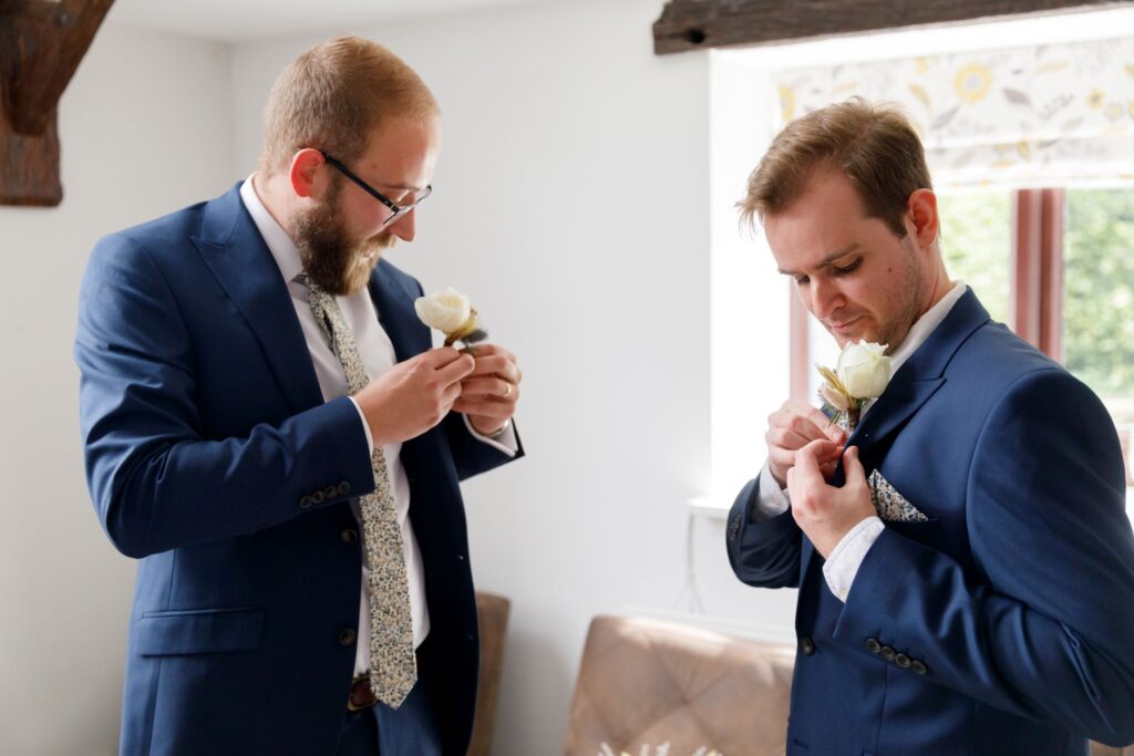 24 groomsmen attach lapel corsages horsley lodge hotel weddking derby s r urwin photography oxfordshire