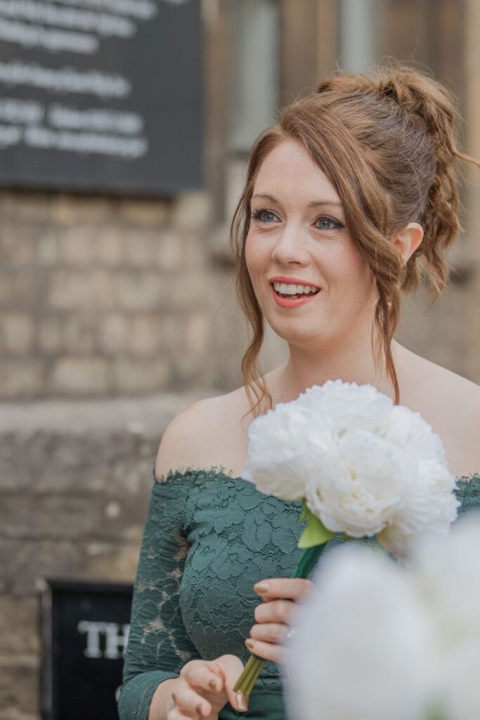27 smiling bridesmaid holds bouquet oxford oratory wedding s r urwin photography oxfordshire