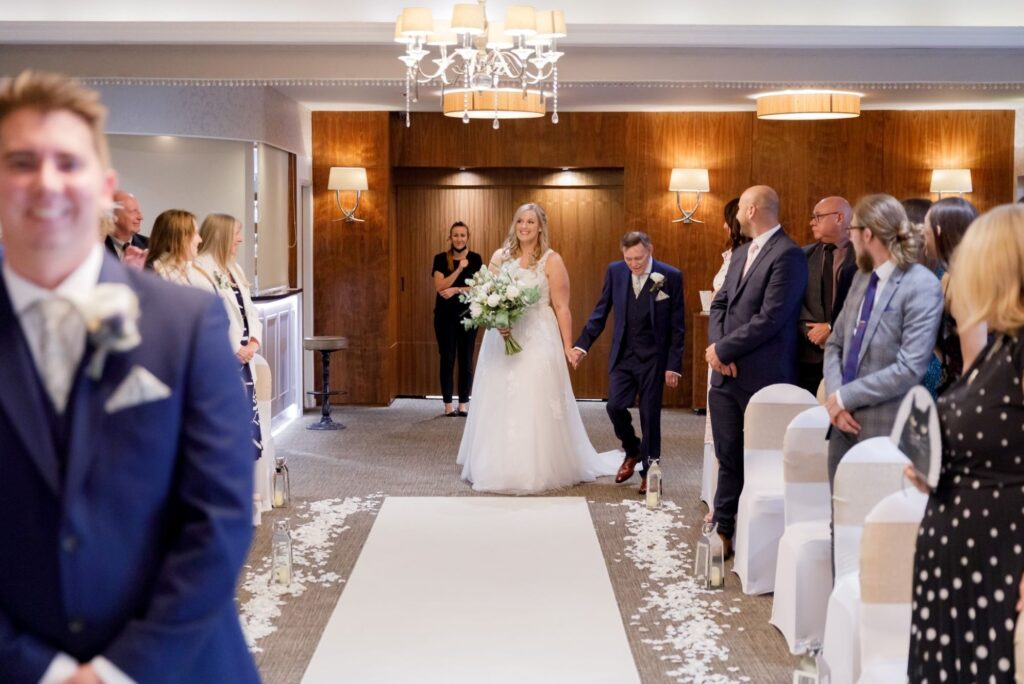 33 bride father of bride enter ceremony room horsley lodge hotel wedding s r urwin photography oxfordshire