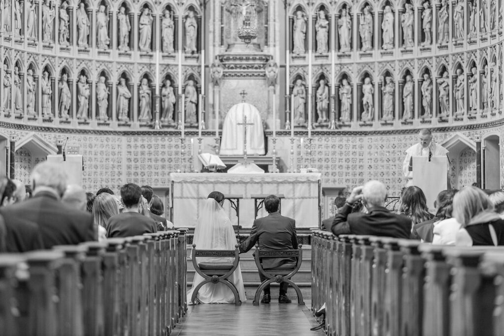 40 bride groom seated priest reads service oxford oratory wedding s r urwin photography