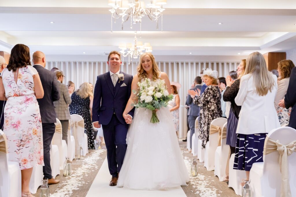 46 guests applaud bride grooms aisle walk horsley lodge hotel wedding ceremony derby s r urwin photography oxfordshire