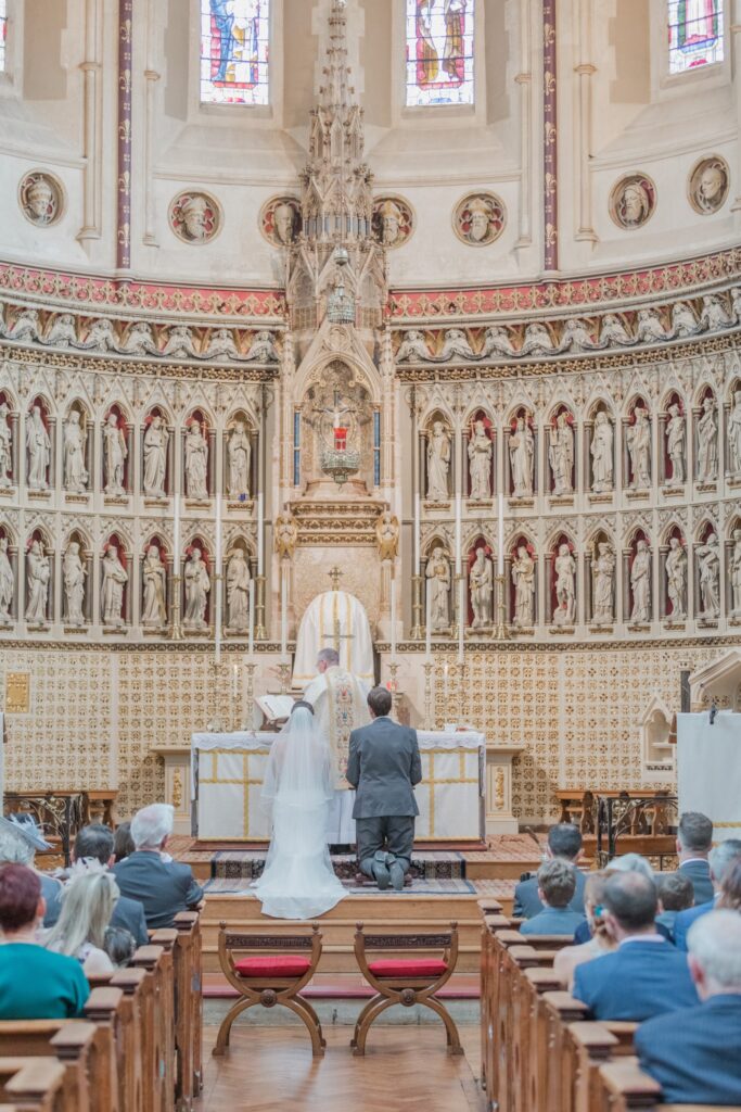 47 bride groom kneel before priest oxford oratory wedding s r urwin photographer oxfordshire