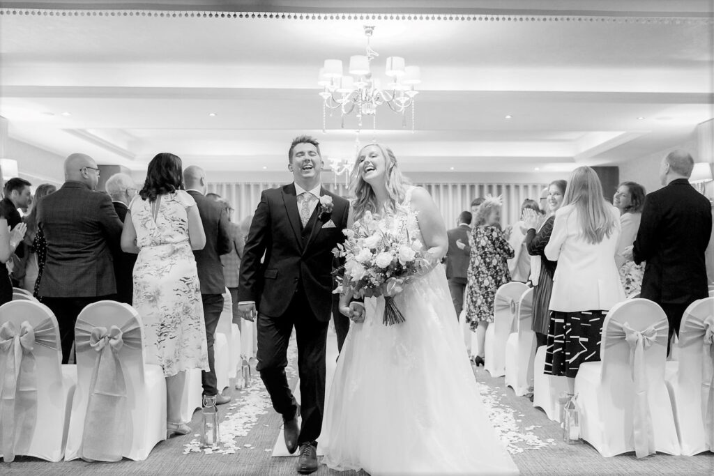 47 laughing bride grooms aisle walk horsley lodge hotel wedding ceremony derby s r urwin photography oxfordshire