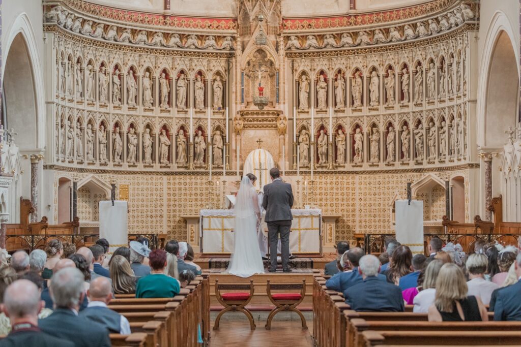 48 bride groom stand before alter oxford oratory wedding s r urwin photographers oxfordshire