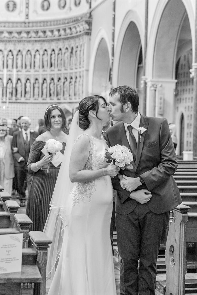 50 bride grooms aisle walk kiss oxford oratory wedding s r urwin wedding photographer oxfordshire