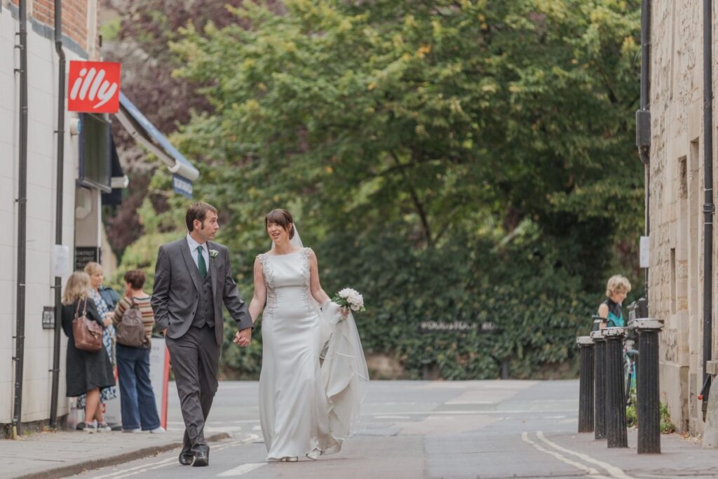57 bride groom walk holding hands oxford city centre oxfordshire wedding photographers