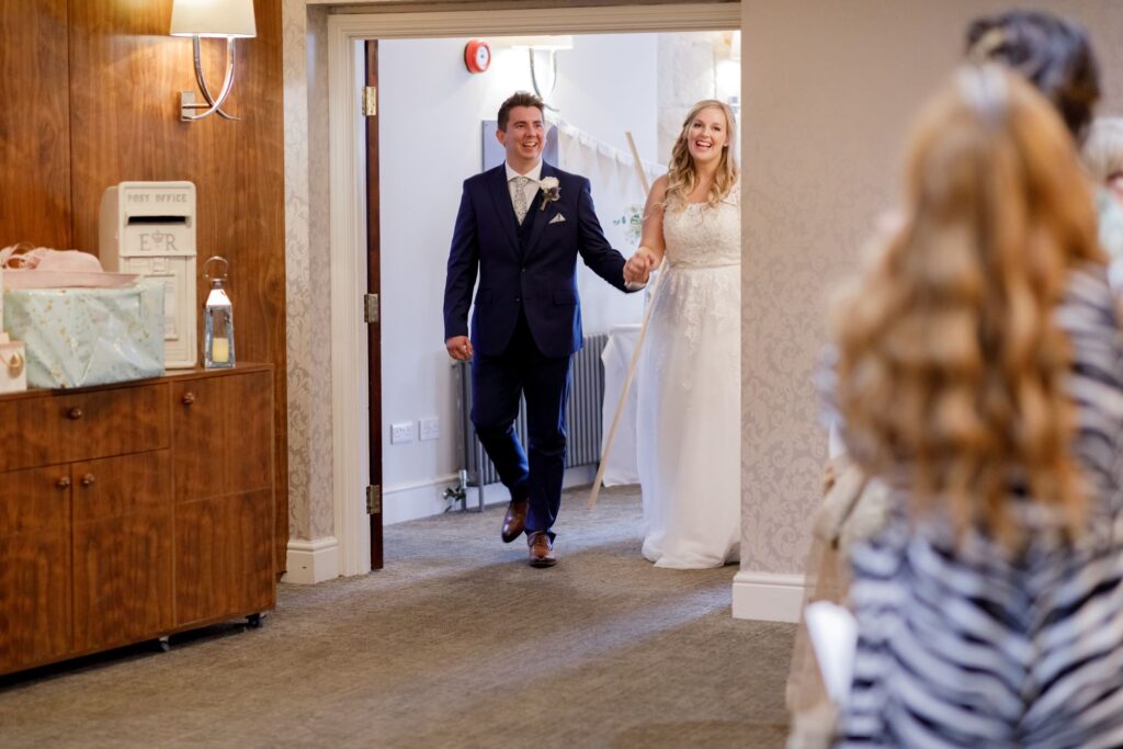71 bride groom enter reception room horsley lodge golf club derby oxfordshire wedding photographer