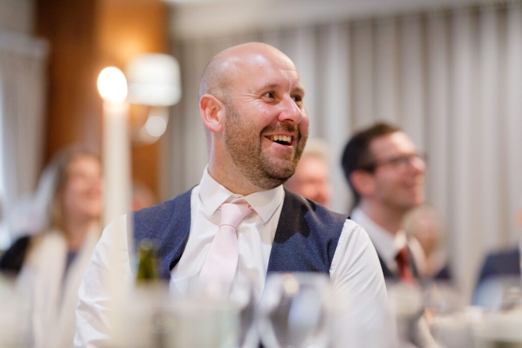 76 laughing guest enjoys grooms speech horsley lodge golf club reception derby oxfordshire wedding photographer