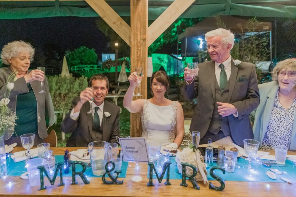 92 top table bridal party raise glasses ye olde swan wedding barn radcot s r urwin photographers oxfordshire