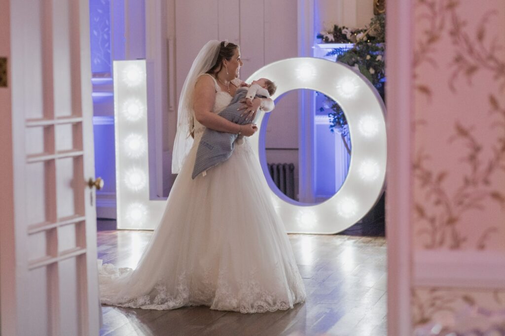 113 bride holds baby shrewsbury venue reception oxford wedding photography