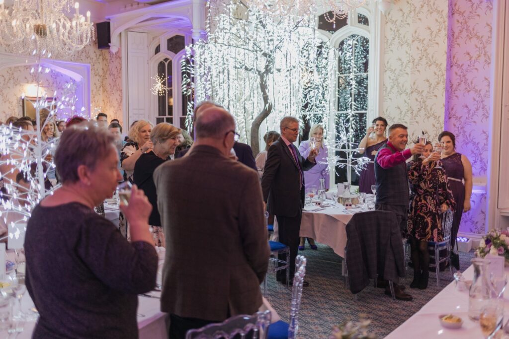 129 guests raise champagne glasses shrewsbury venue reception oxfordshire wedding photographers