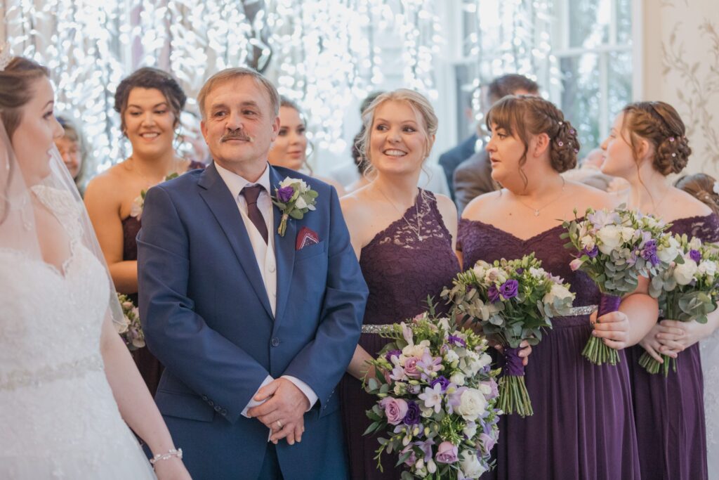 63 smiling bridemaids hold bouquets marriage ceremony shrewsbury oxford wedding photography