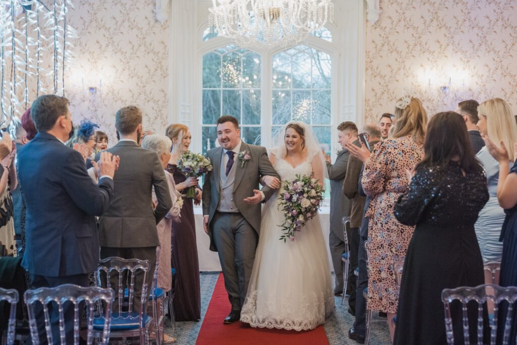 85 guests applaud happy bride grooms aisle walk shrewsbury ceremony oxford wedding photographer