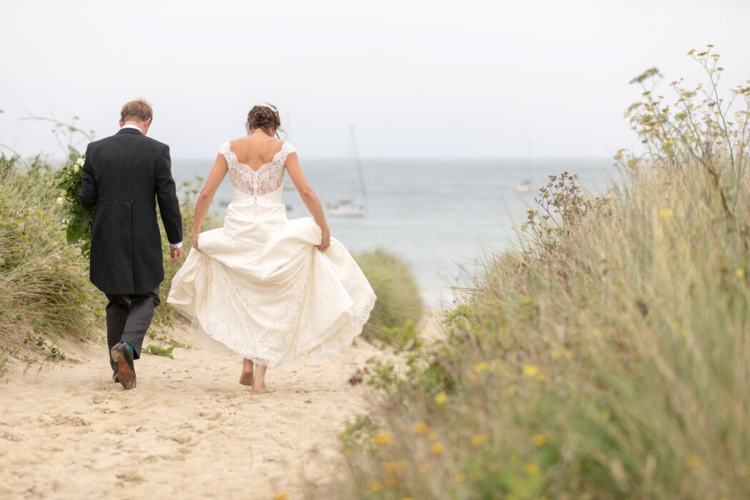 bride groom walk among sand dunes alderney channel islands oxfordshire destination wedding photographers