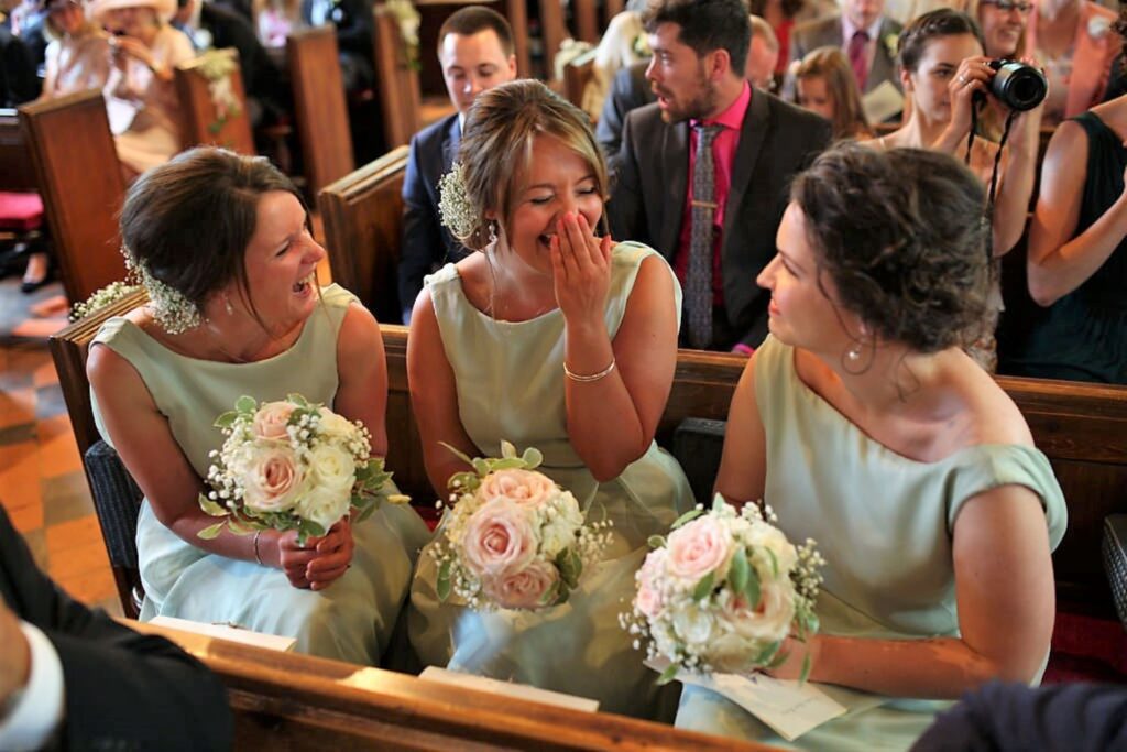 02 giggling bridesmaids church marriage ceremony s r urwin wedding photographers oxford