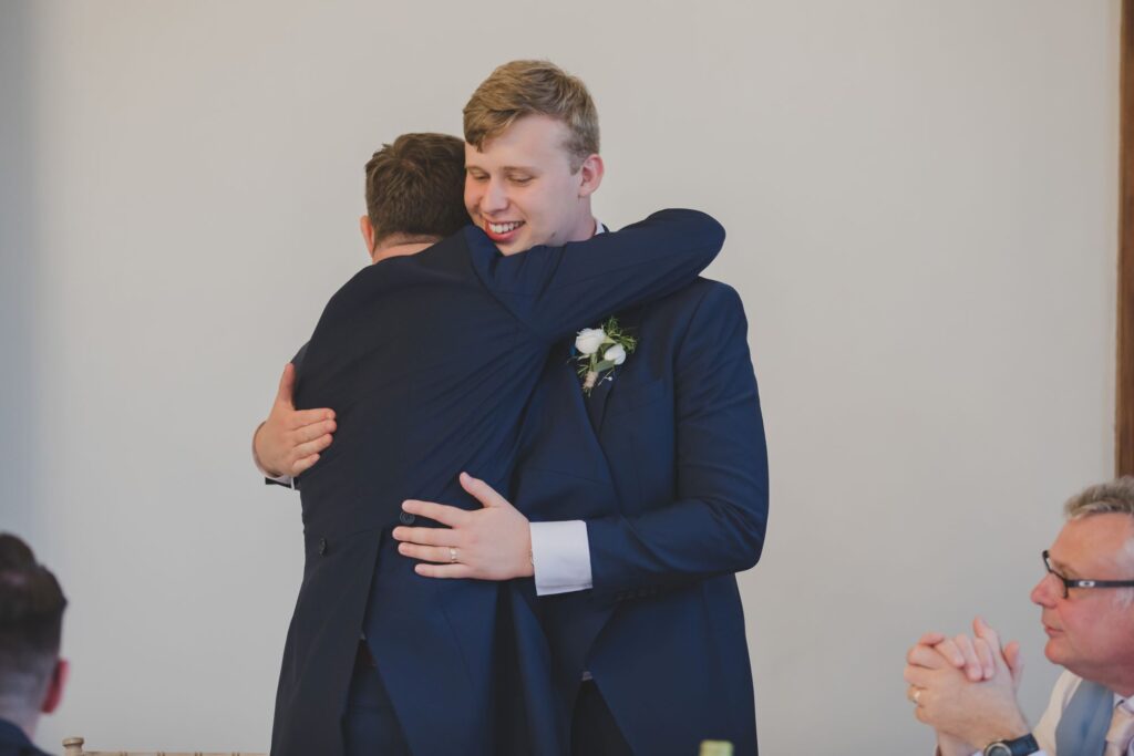 101 groom hugs bestman thorganby reception north yorkshire oxfordshire wedding photography