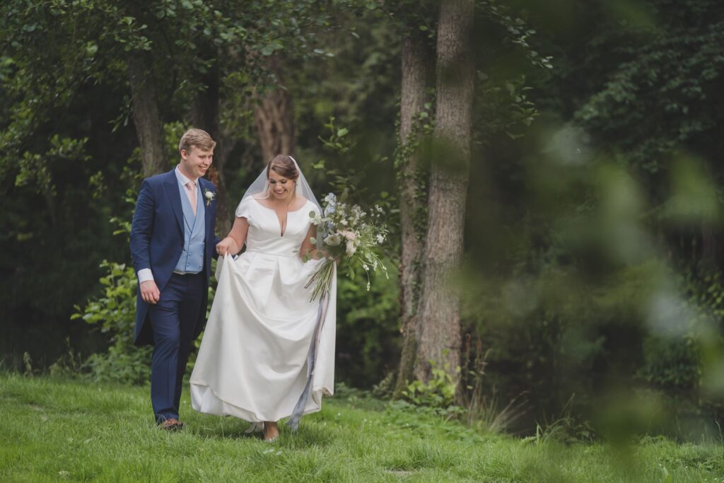 107 smiling bride groom stroll grounds thorganby venue north yorkshire oxfordshire wedding photography