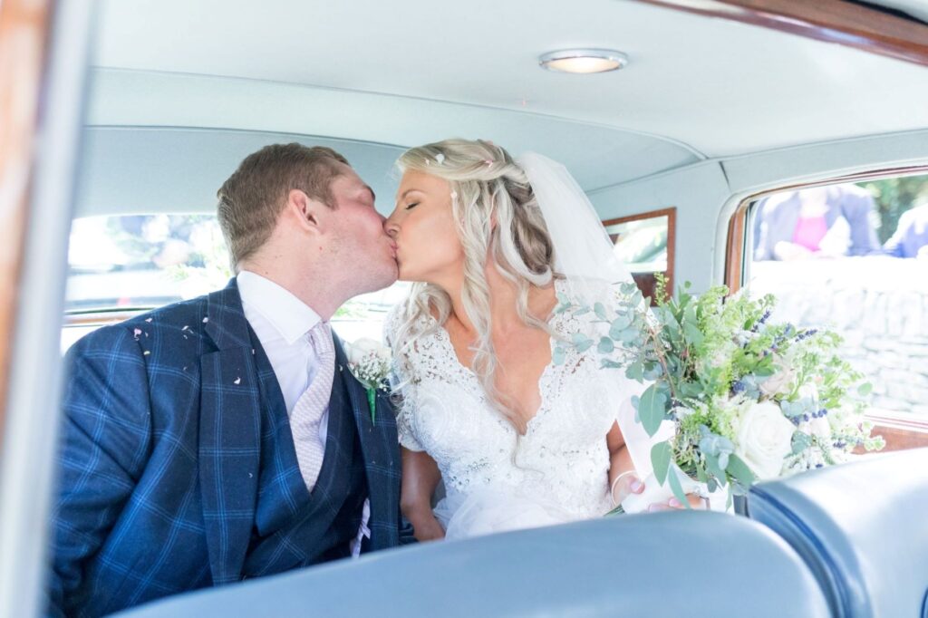 27 bride groom kiss inside bridal car cote baptist chapel oxfordshire oxford wedding photographer