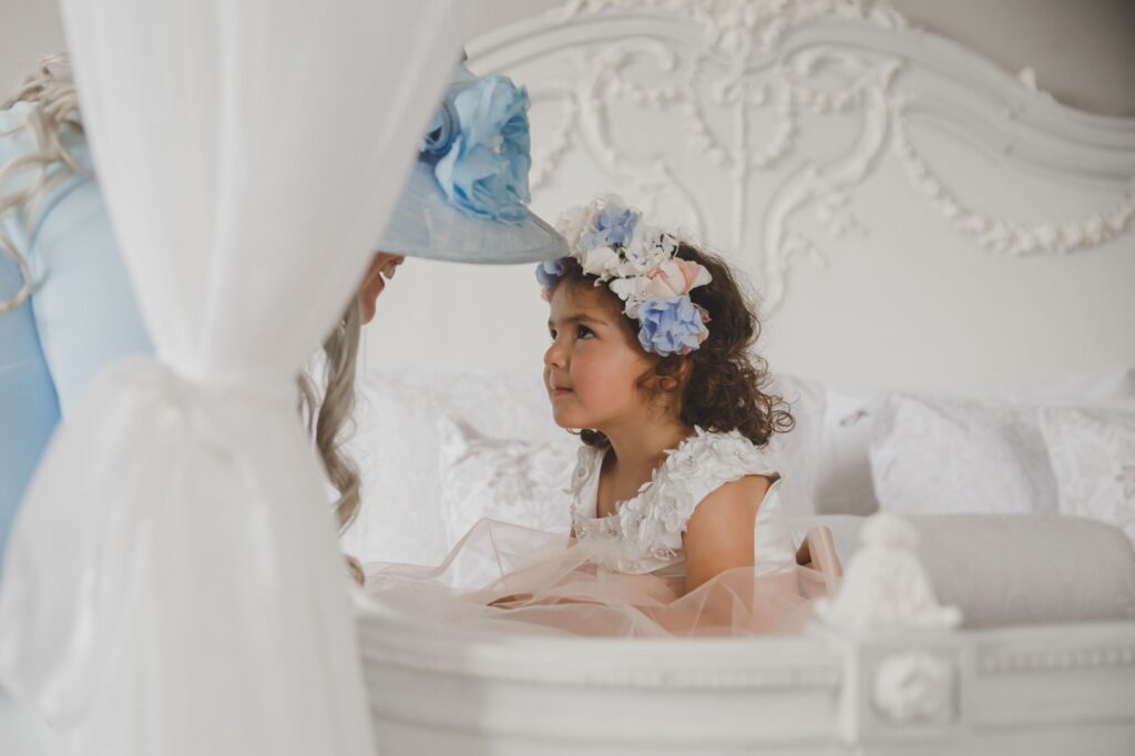 33 flowergirl lies on bed bridal prep thicket priory york oxfordshire wedding photographer