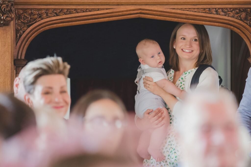 71 smiling guest holds baby thorganby venue ceremony north yorkshire oxford wedding photography