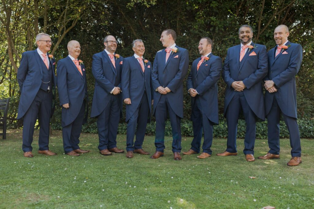 25 laughing groom groomsmen hunton park hotel gardens hertfordshire oxford wedding photographer