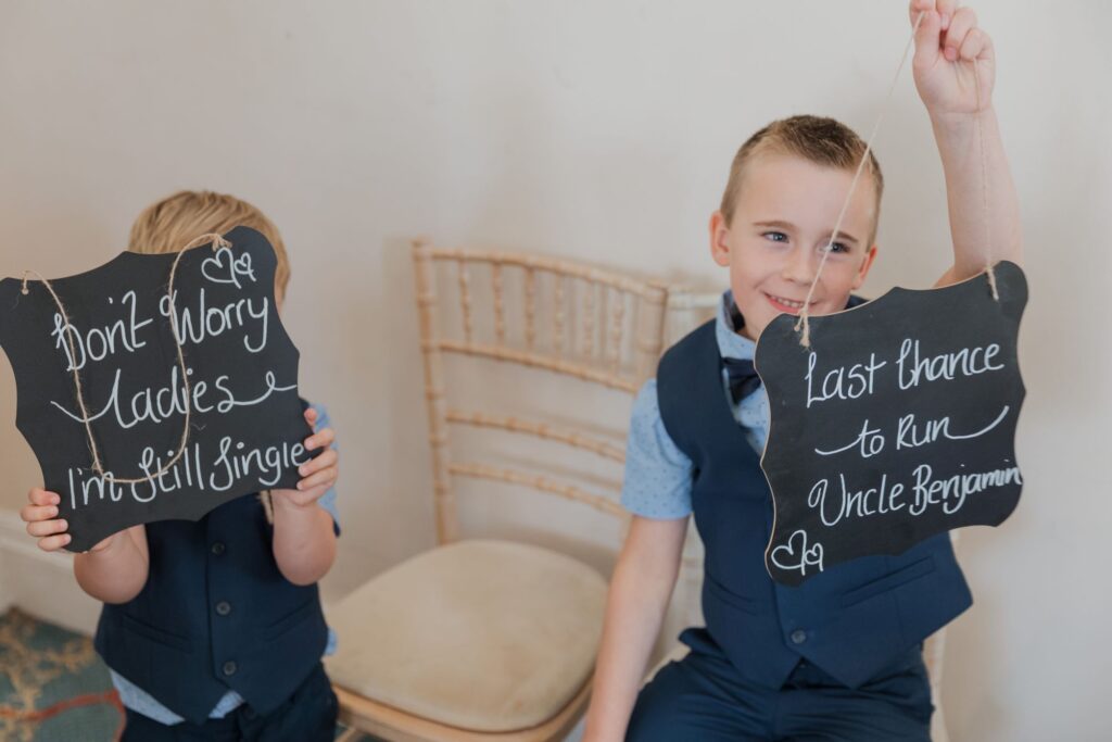 36 page boys hold signs kings langley ceremony watford oxfordshire wedding photography
