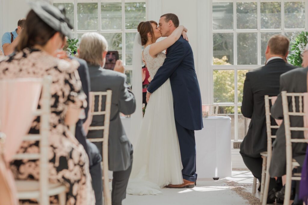 57 groom kisses bride marriage ceremony kings langley watford oxfordshire wedding photographer