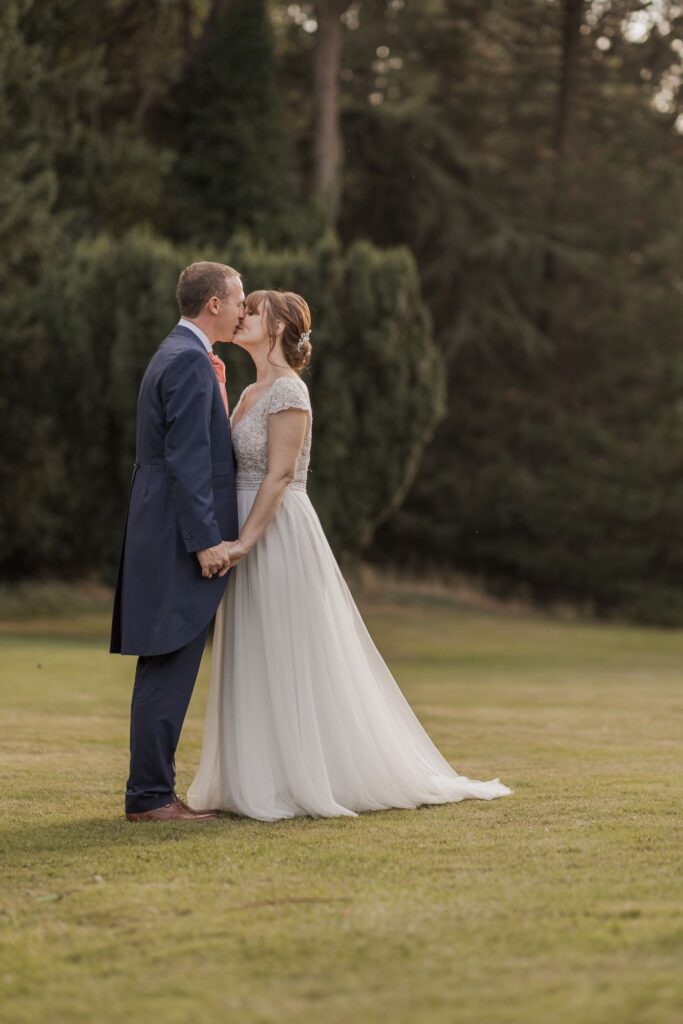 95 bride groom kiss kings lanley hotel grounds hertfordshire oxfordshire wedding photographers