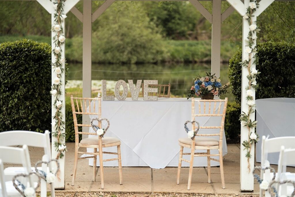 06 flower decked outdoor ceremony venue voco oxford thames oxfordshire wedding photography