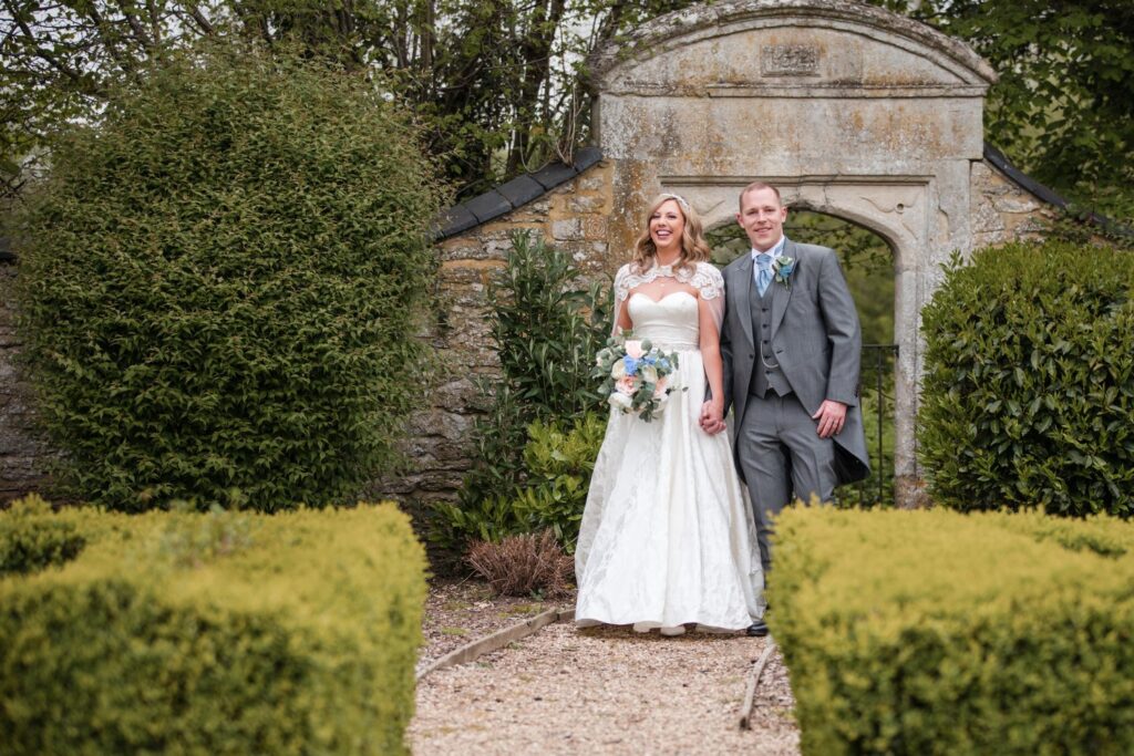 125 smiling bride groom hold hands ihg hotel sandford oxford oxfordshire wedding photographer