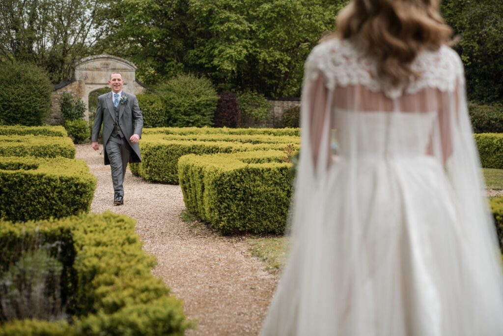 128 groom walks towards bride ihg hotel gardens sandford oxford oxfordshire wedding photographer