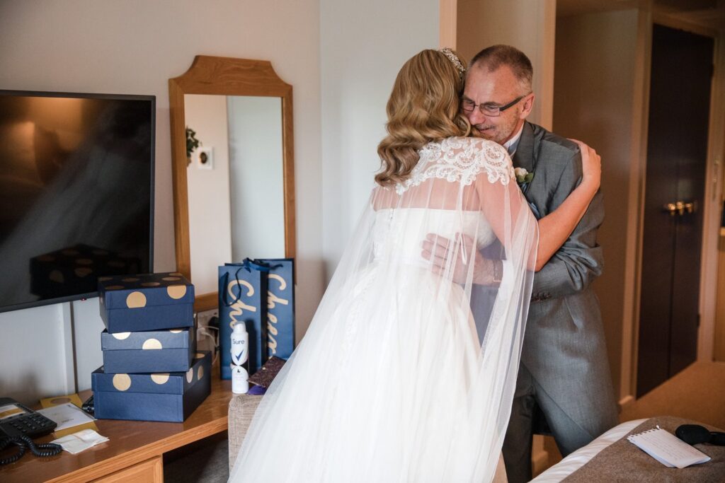 32 bride embraces father after first look voco oxford thames oxfordshire wedding photography