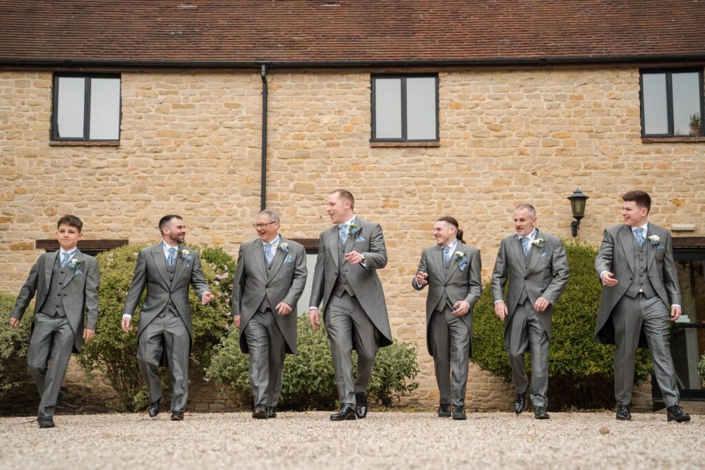 35 laughing groom groomsmen voco oxford thames hotel grounds oxfordshire wedding photographers