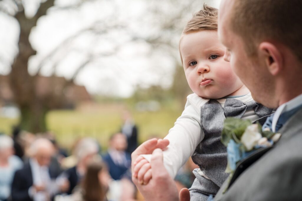 38 groom holds toddler ihg hotel outdoor ceremony sandford oxford oxfordshire wedding photographers