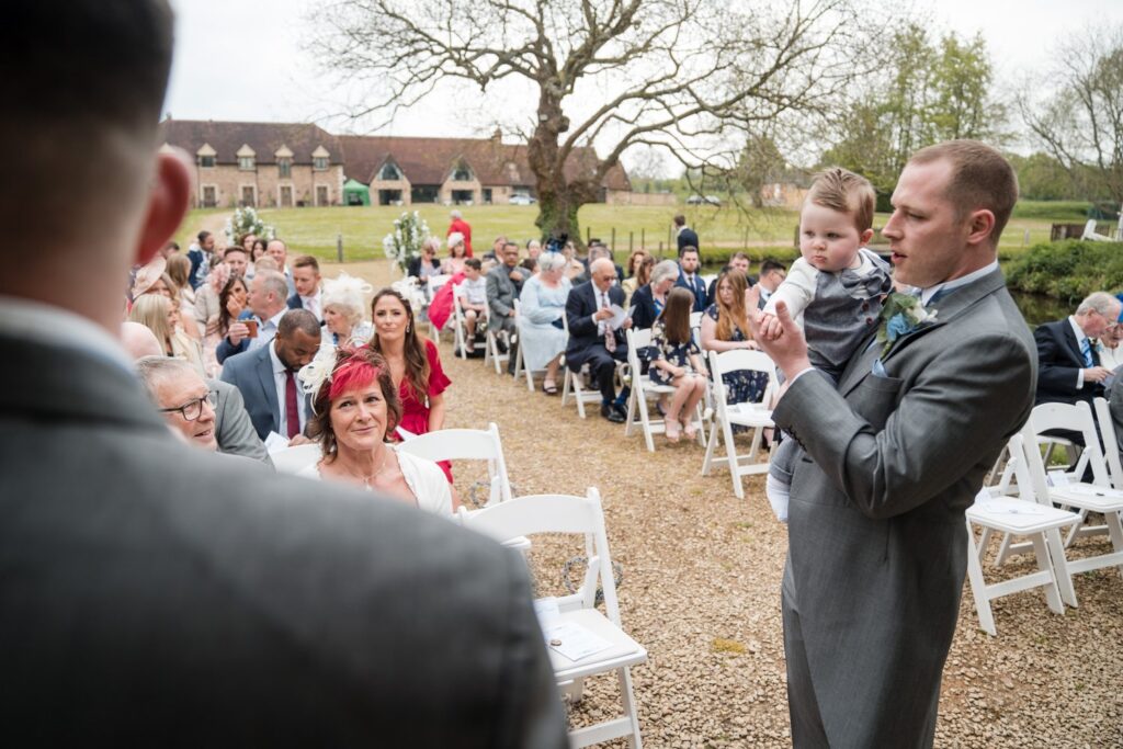 39 guests await brides arrival ihg hotel outdoor ceremony sandford oxford oxfordshire wedding photography