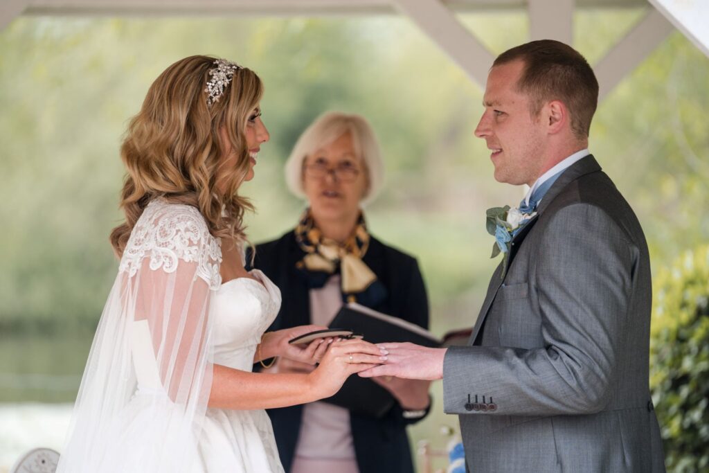71 bride gives groom ring ihg hotel outdoor ceremony sandford oxford oxfordshire wedding photography