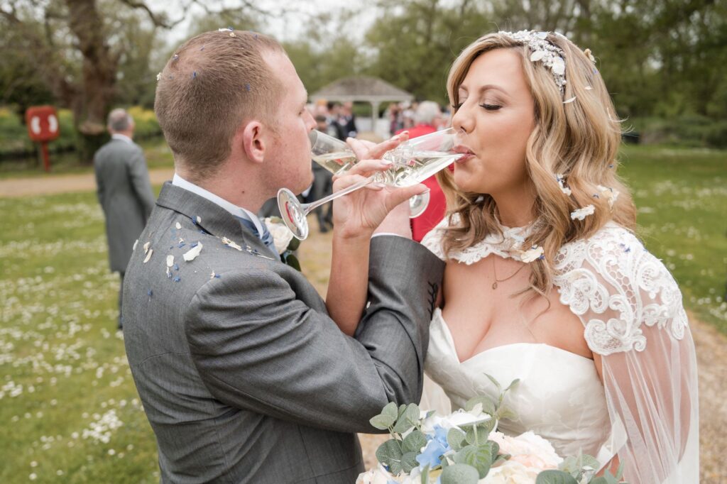 91 bride groom sip champagne ihg hotel grounds sandford oxford oxfordshire wedding photographers