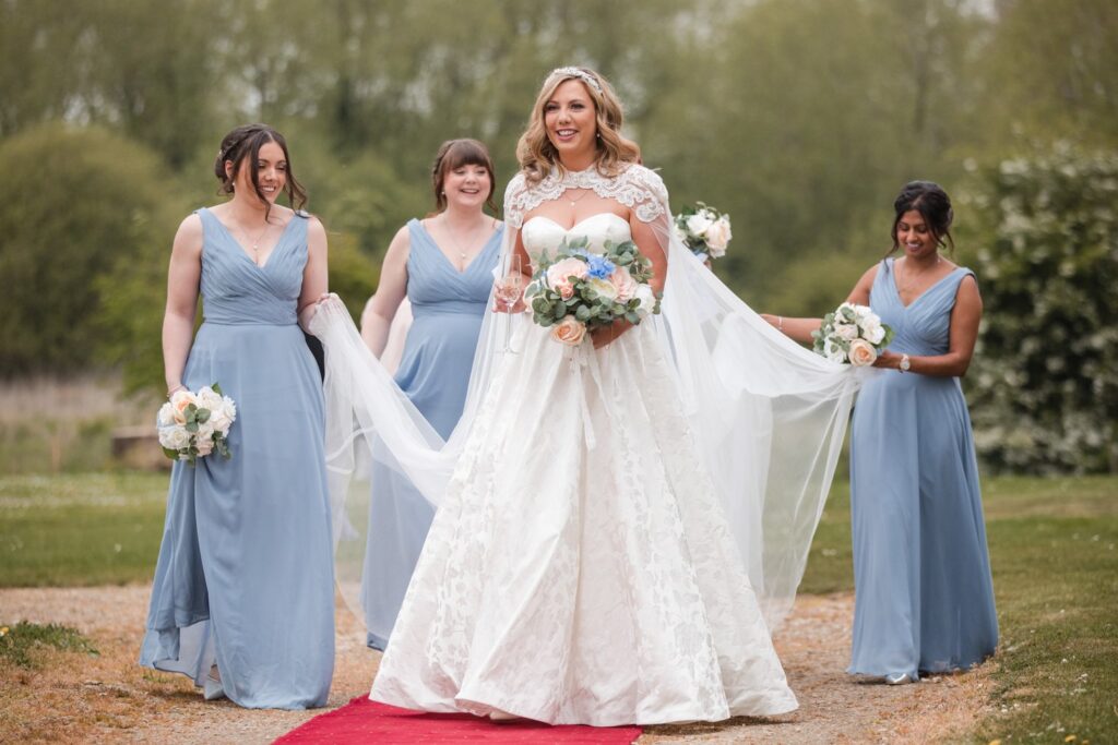 95 bridesmaids carry brides train ihg hotel grounds sandford oxford oxfordshire wedding photography
