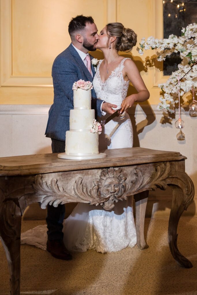 111 bride groom kiss cake cutting ceremony euridge manor chippenham wiltshire oxfordshire wedding photographers
